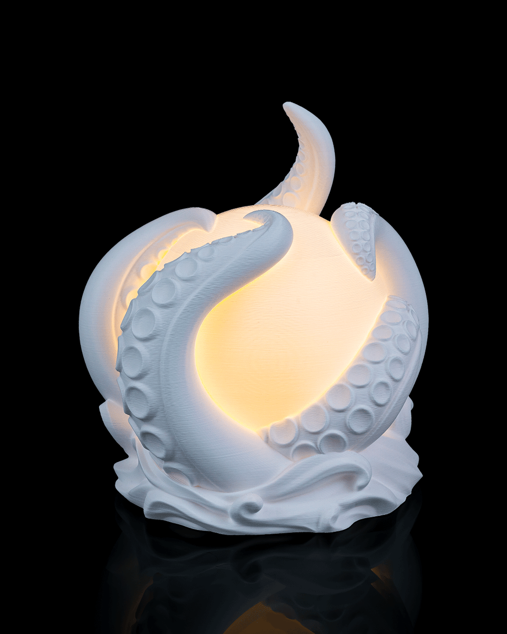 White ceramic moon-shaped lamp with a glowing interior on a black background