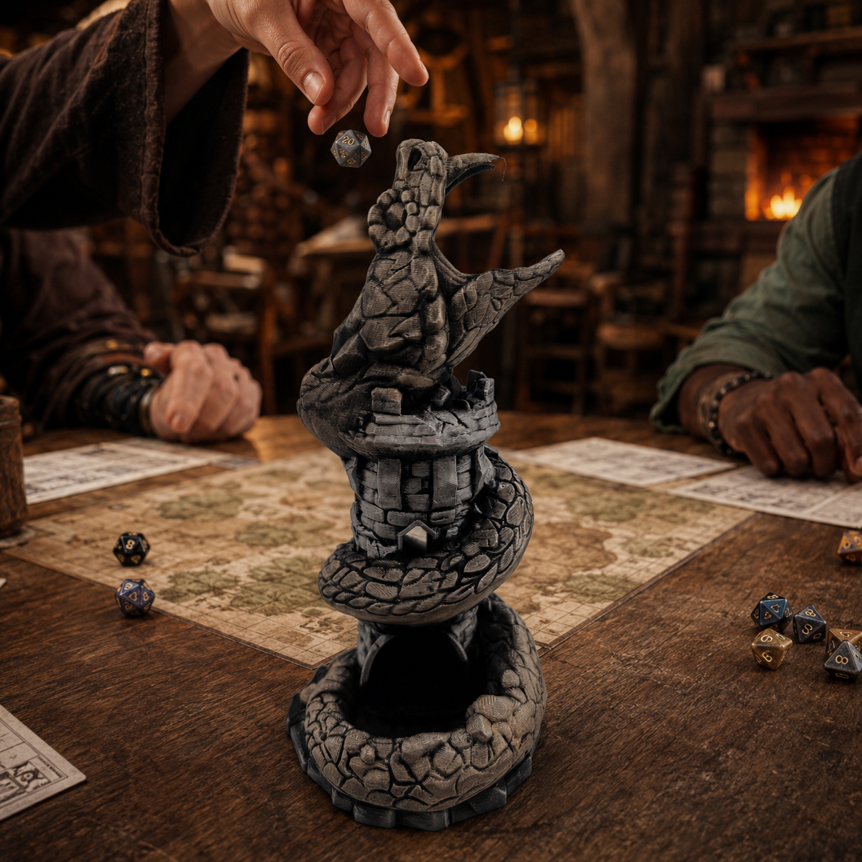 A gray stone-serpent tower miniaturized tabletop terrain piece featuring a raven perched atop a stone tower and coiled serpent base, shown on a wooden gaming table during a fantasy tabletop scene with players' hands and dice visible.