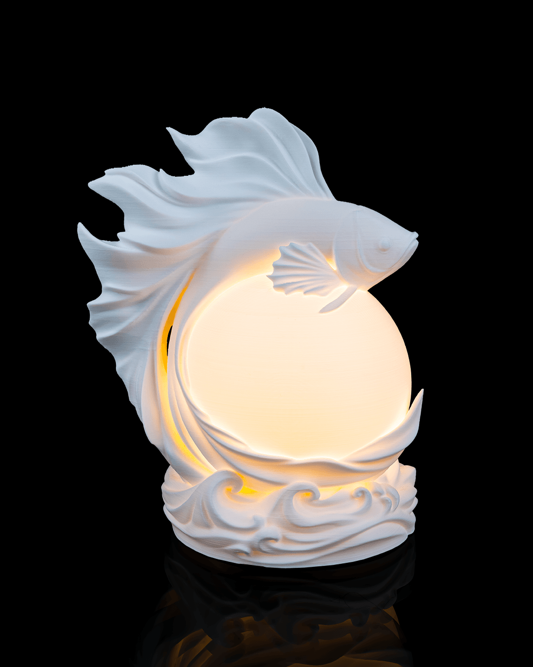 Decorative lamp shaped like a fish with a glowing interior on a black background