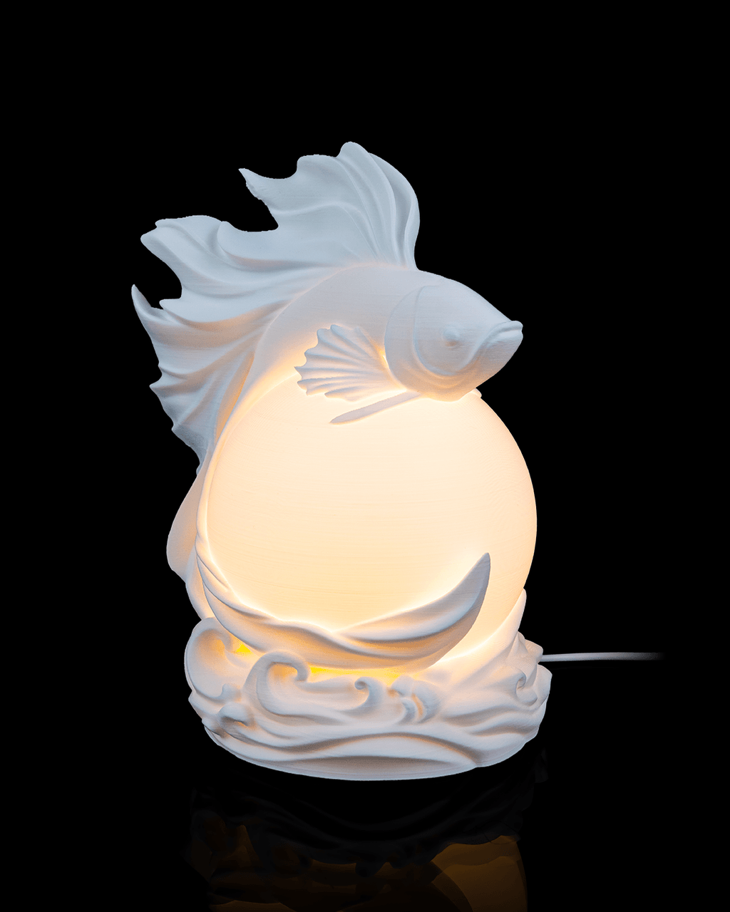 Decorative fish-shaped night light on a black background