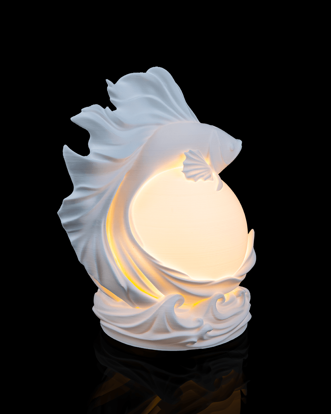 White ceramic fish-shaped night light on a black background