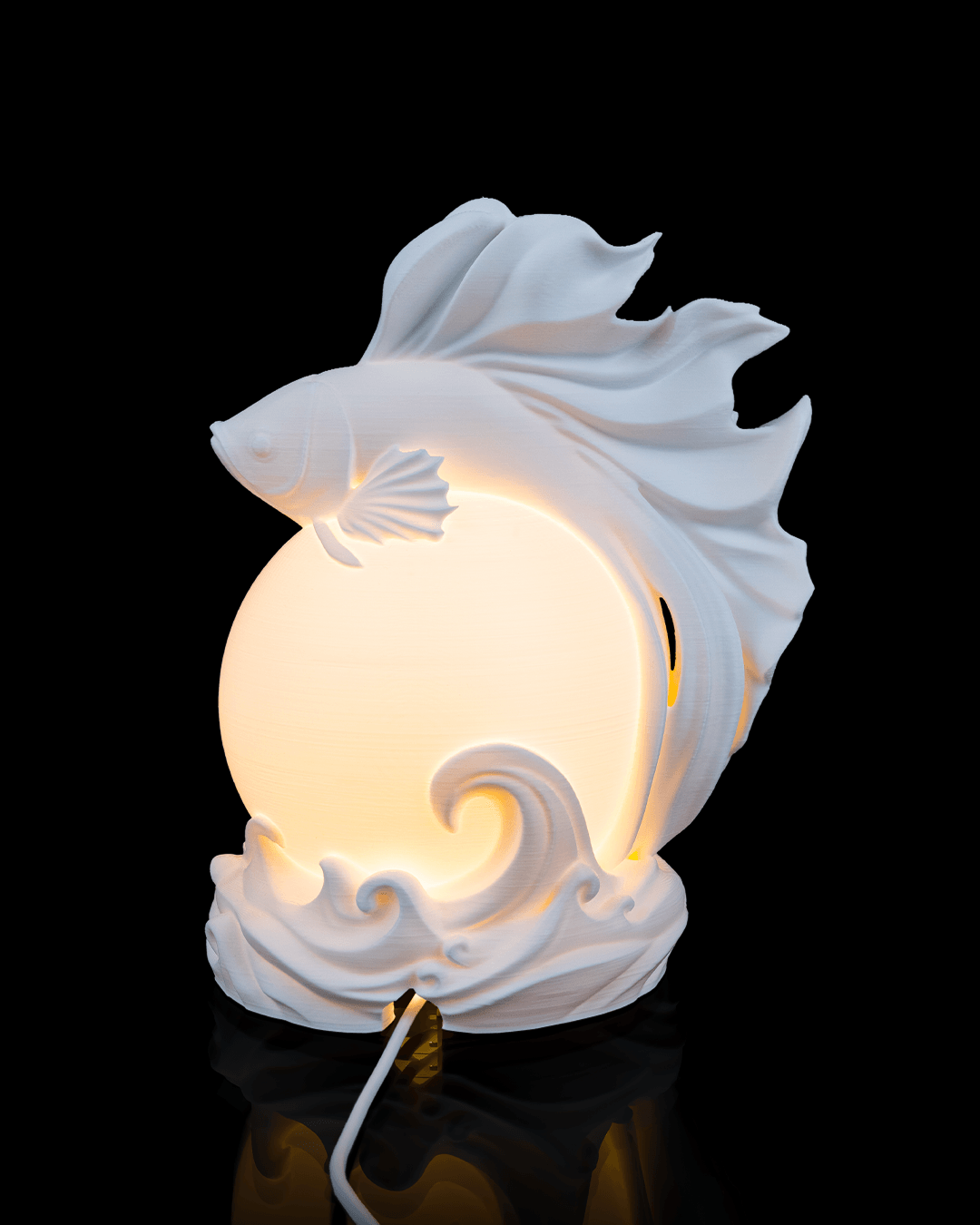 Decorative wall light with fish design on a black background