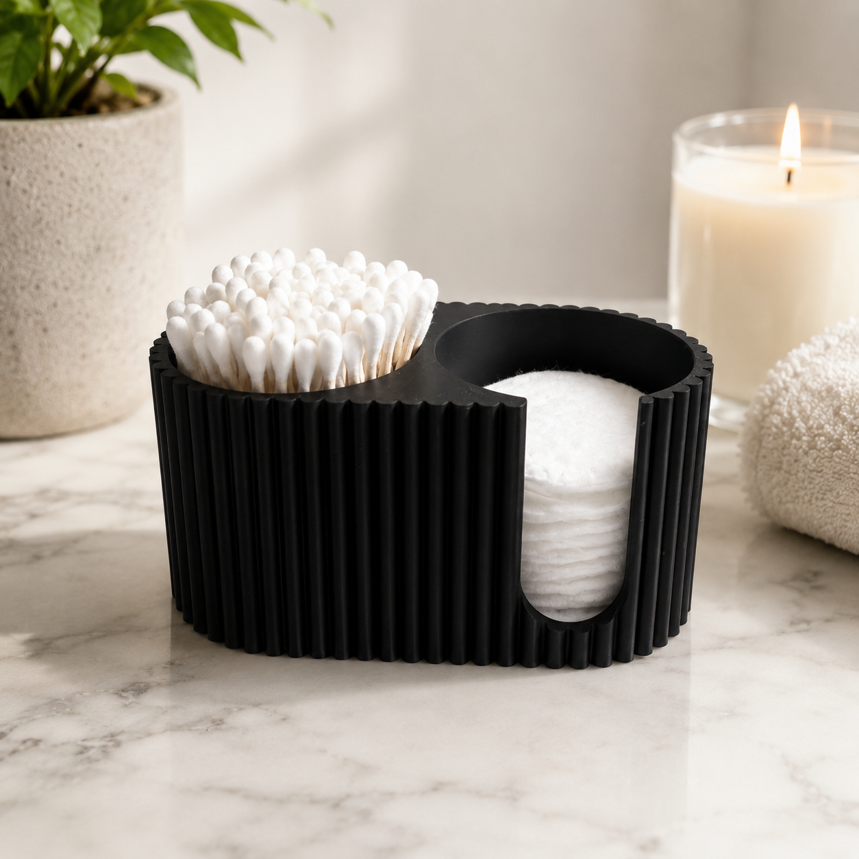 Modern black ribbed cotton swab and cotton pad organizer displayed on a stylish bathroom vanity.