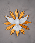 Decorative wall art with a white dove and yellow rays on a gray background
