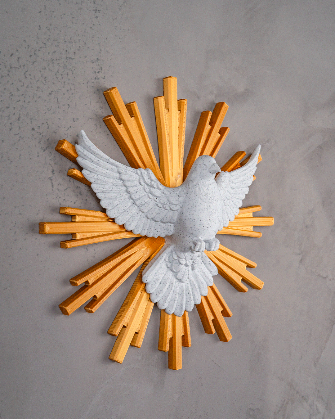 Decorative wall art with a white dove and gold rays on a gray background