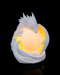 White dragon-shaped night light with a glowing yellow center on a black background
