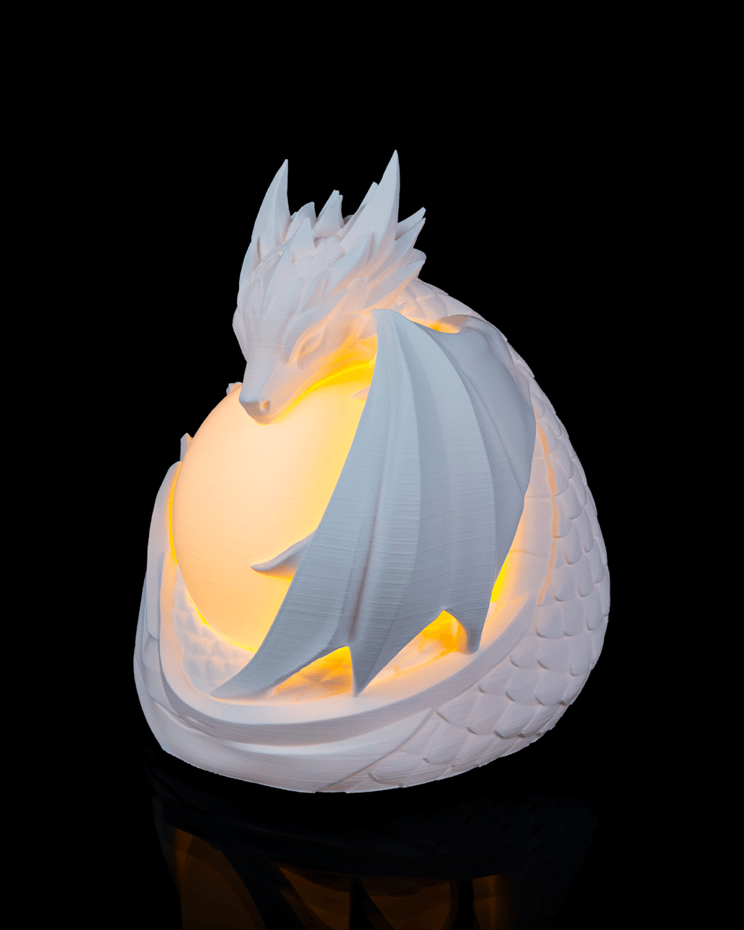Dragon-shaped night light with glowing interior on a black background