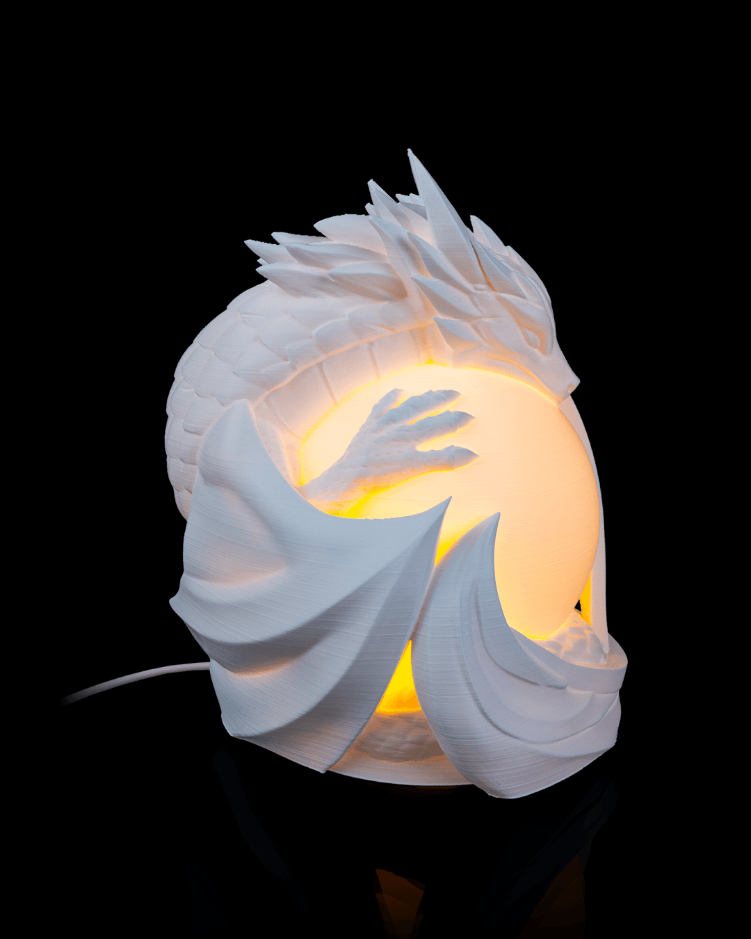 White dragon-shaped lamp with a glowing interior on a black background