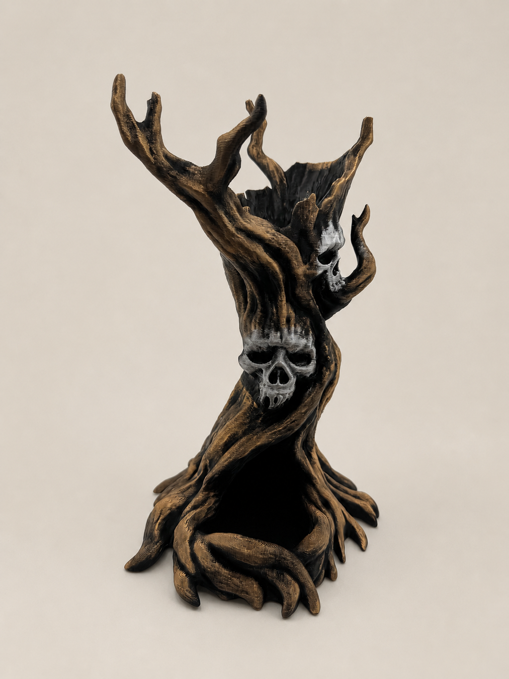 A gothic decorative sculpture of a gnarled tree trunk with skull details, set against a plain beige background.