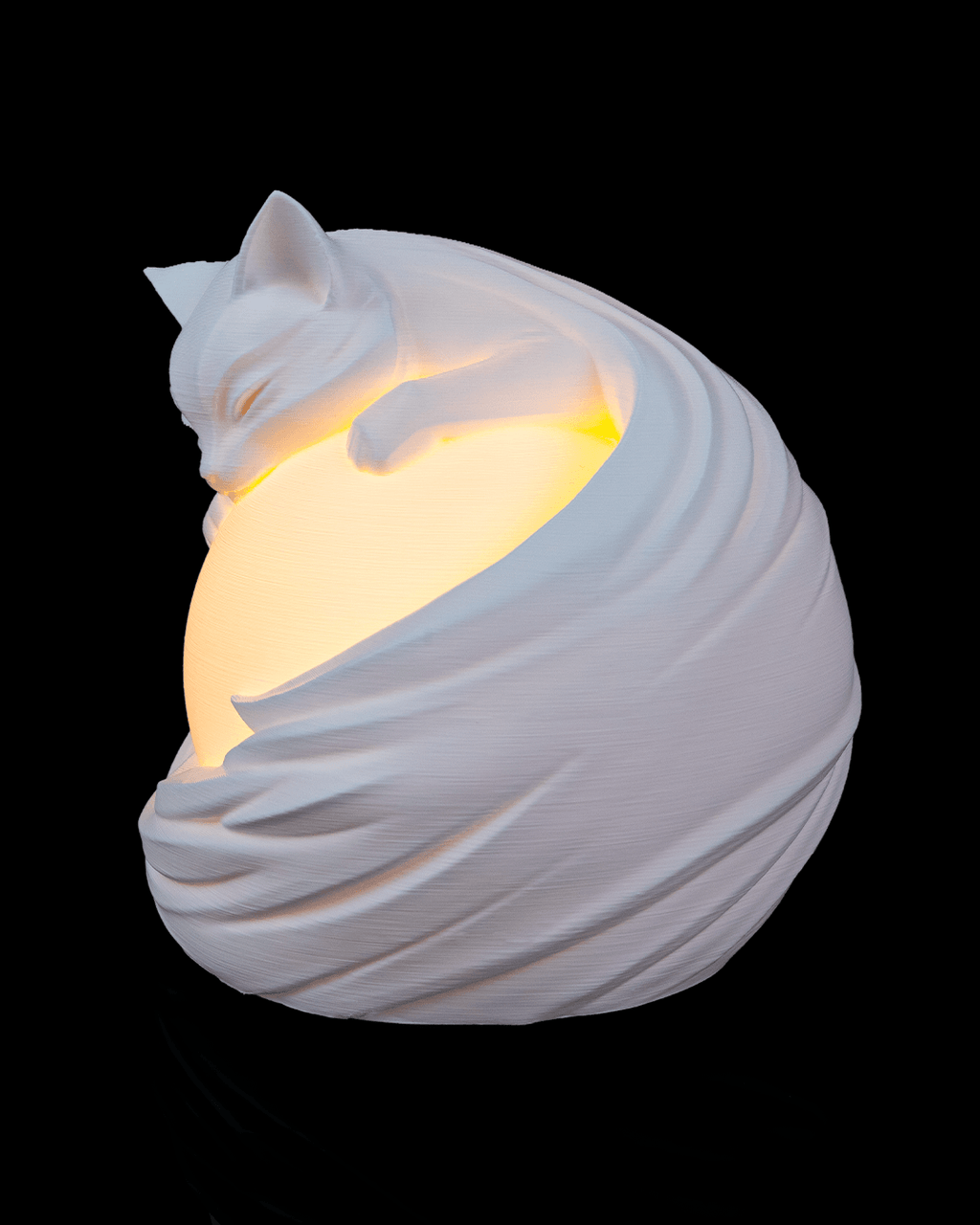 Ceramic cat-shaped night light on a black background