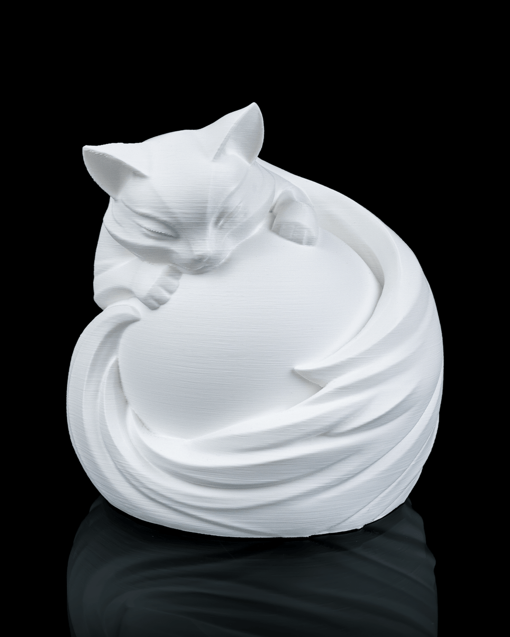 White ceramic cat sculpture on a black background