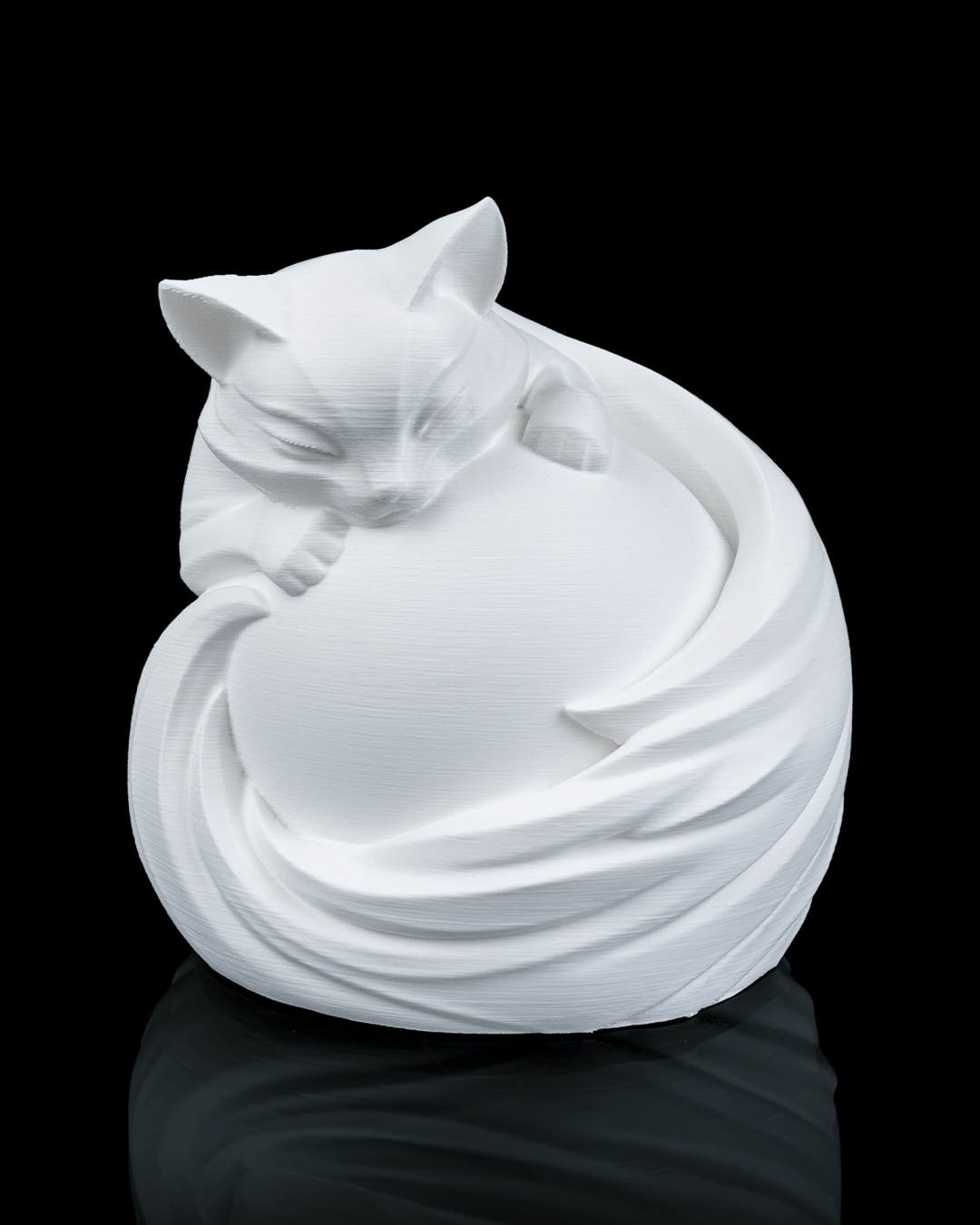 White ceramic cat sculpture on a black background