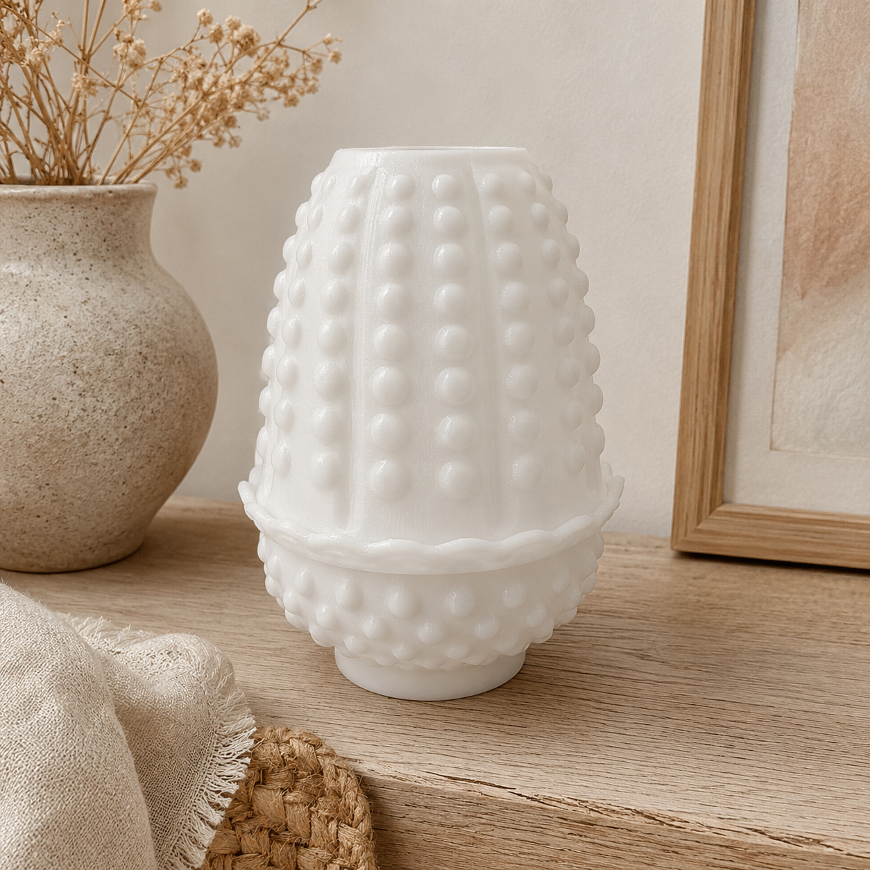 White hobnail fairy lamp styled on a neutral wood shelf with dried flowers, linen fabric, and cozy handmade home décor accents.