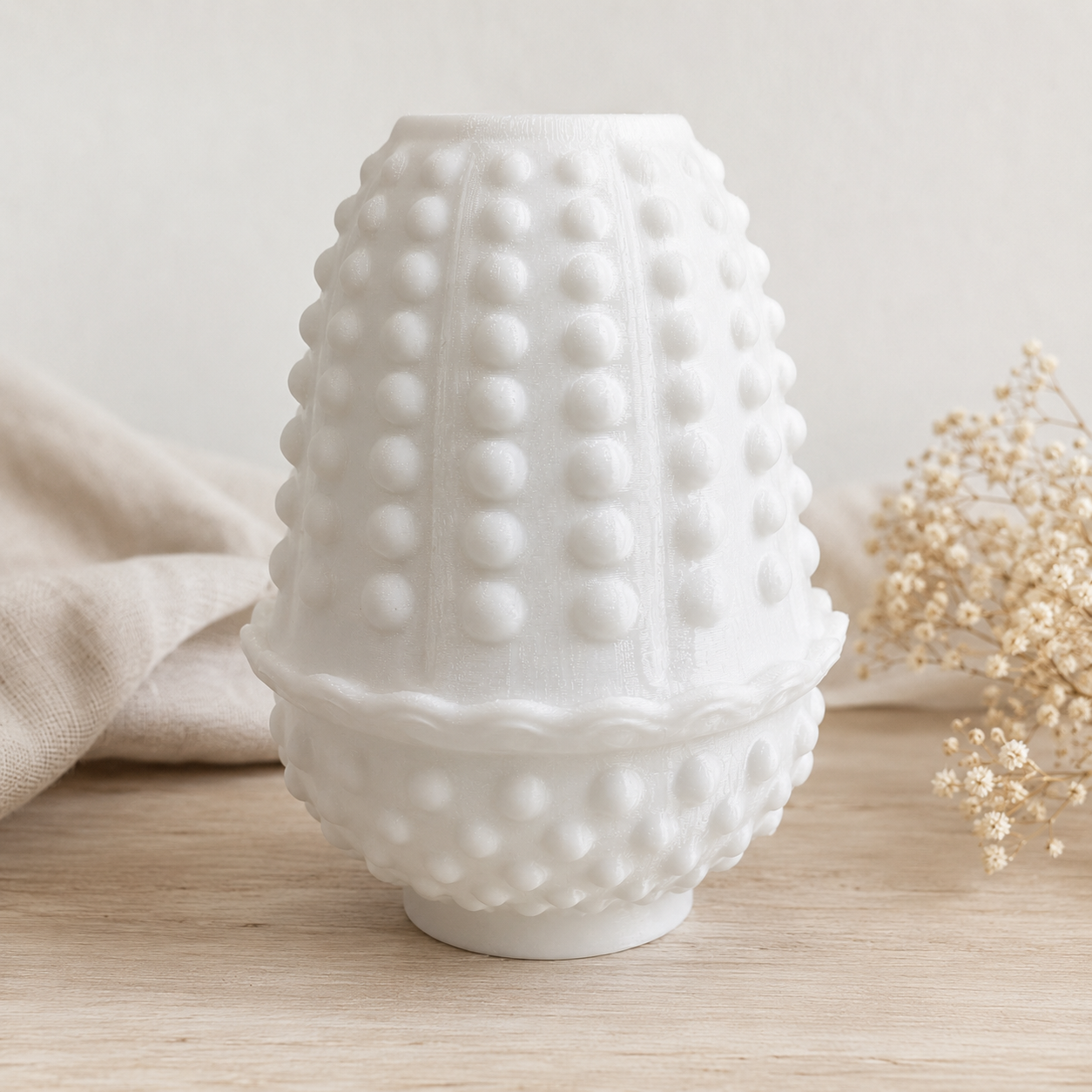 White hobnail fairy lamp displayed as a collectible gift with neutral fabric pouch, dried floral accents, and soft elegant lighting.