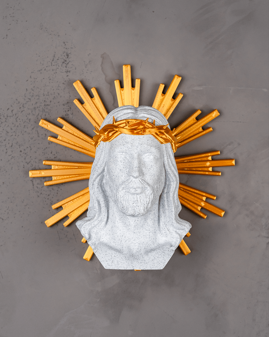 Decorative wall piece with a bust of a bearded figure and gold sunburst on a gray background