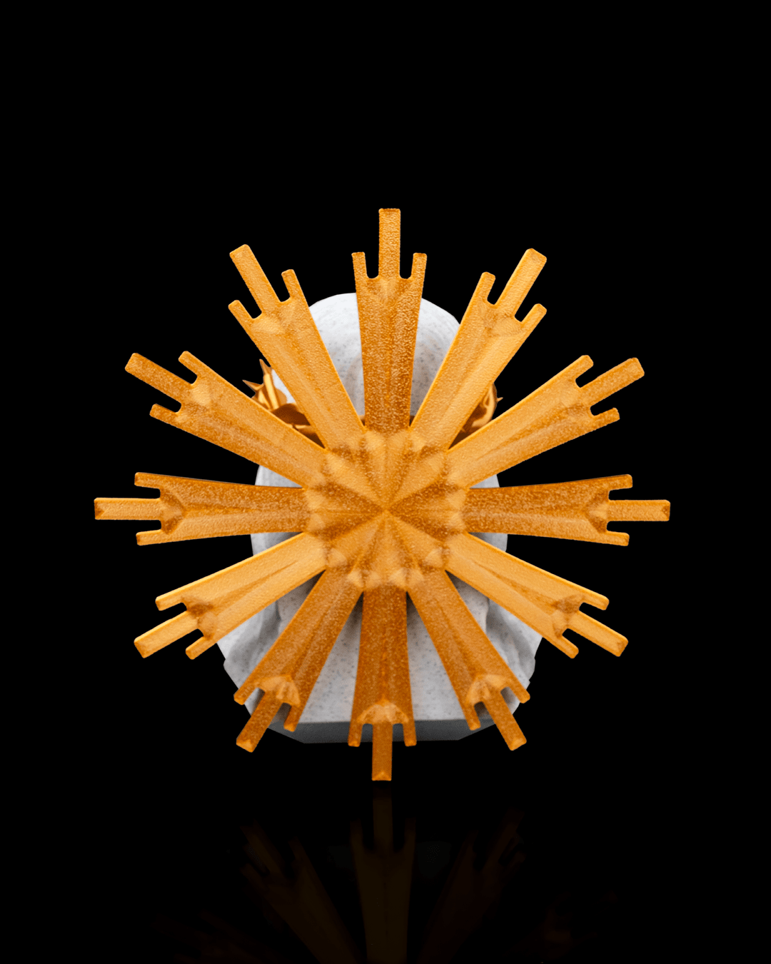 Decorative object with orange spikes on a black background