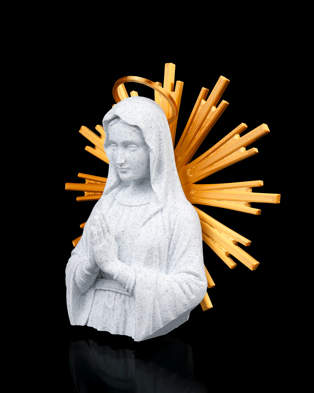Statue of a religious figure with a yellow halo on a black background