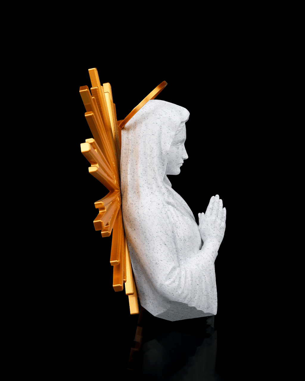 Statue of a praying figure with a gold halo on a black background