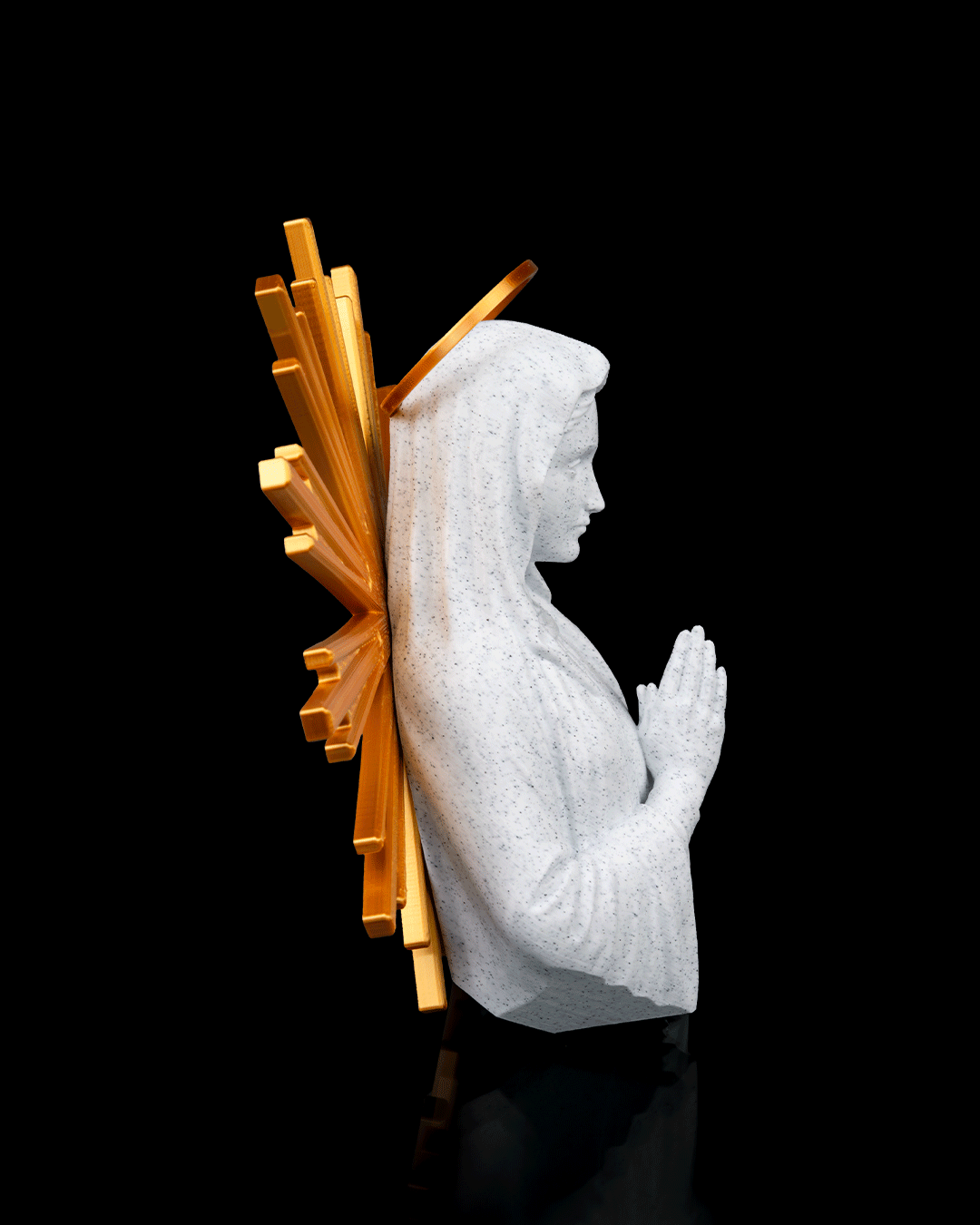 Statue of a praying figure with a gold halo on a black background