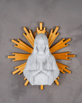 Statue of a religious figure with a wooden sunburst design on a gray background