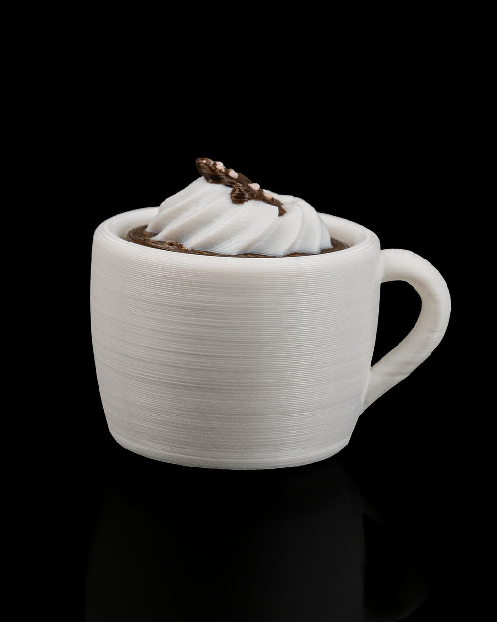 White ceramic mug with a chocolate dessert on a black background