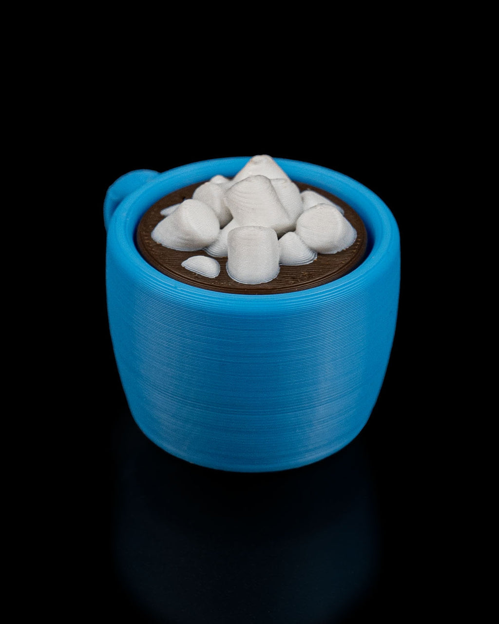 Blue container with white stones on a black background