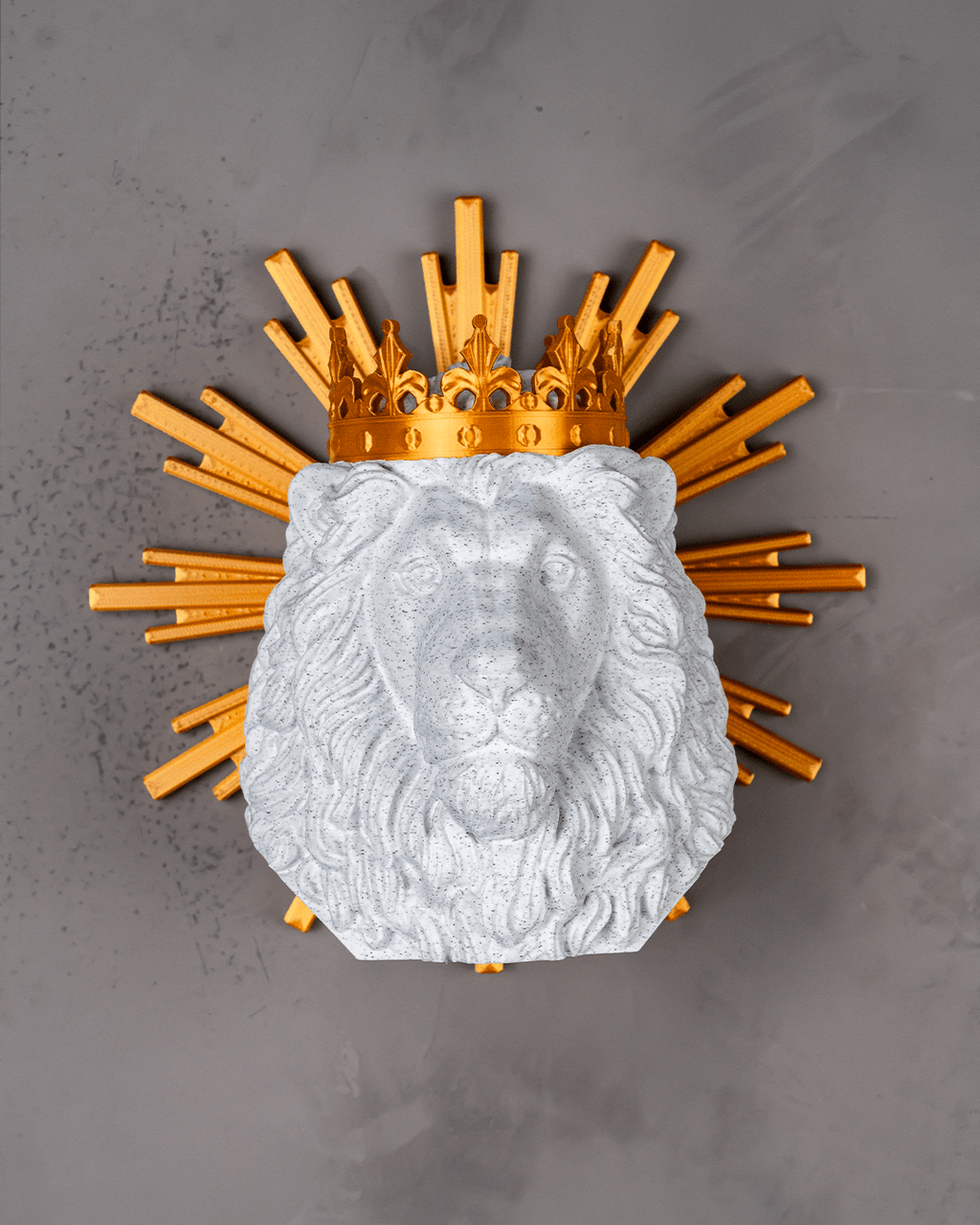Decorative wall piece with lion head and gold crown on a gray background