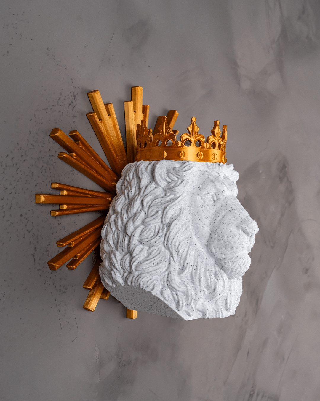 Decorative wall piece with lion head and gold crown on a gray background