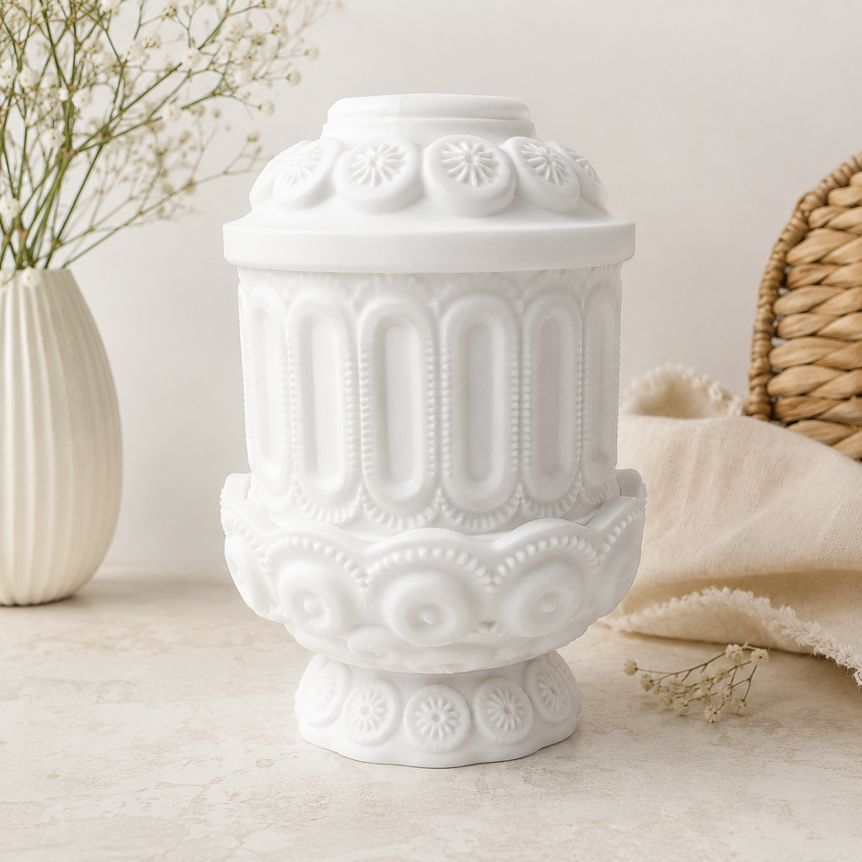 White vintage-inspired decorative fairy lamp with ornate raised details displayed in a soft neutral lifestyle setting.