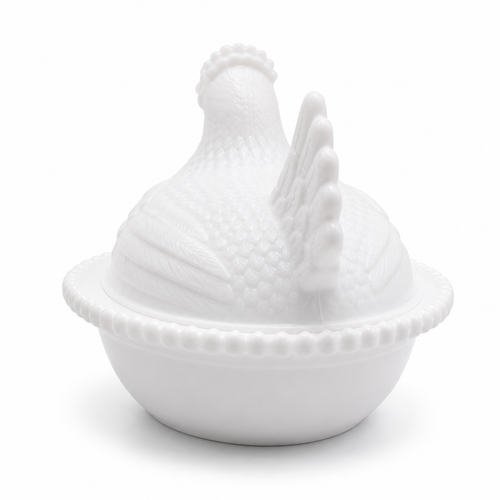 Rear view of the white hen on nest dish highlighting sculpted tail and feather details.