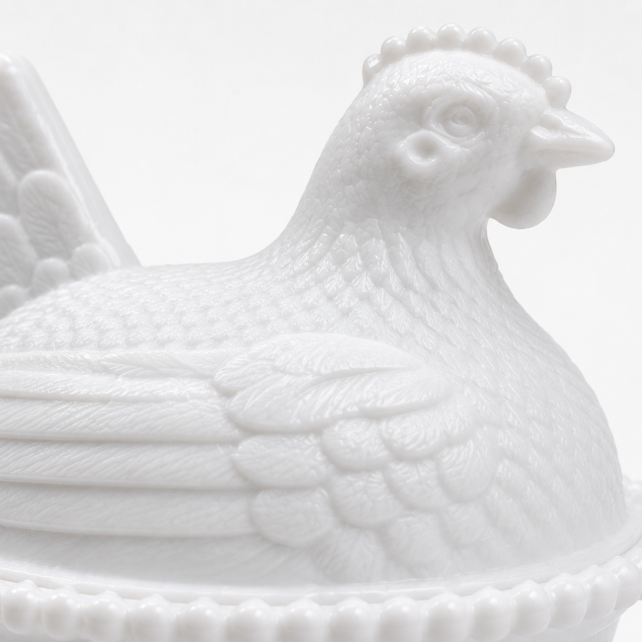 Close-up of the Indiana Glass style hen lid showing intricate feather texture and craftsmanship.