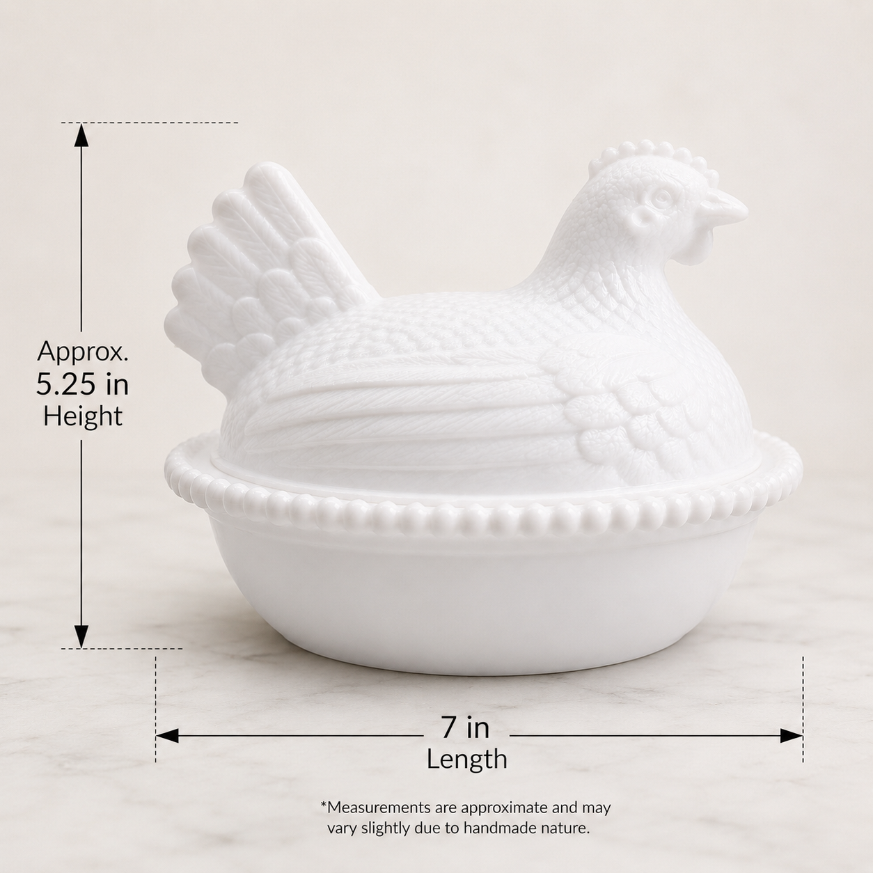 Front view of a white milk glass style hen on nest dish on a clean white background with dimensions for large.