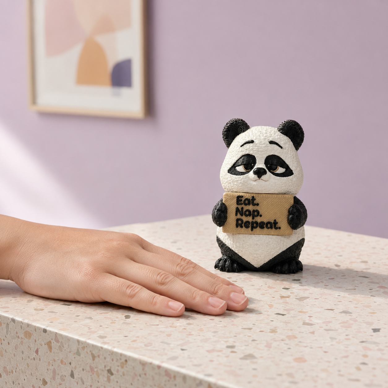 A small panda figurine holding a sign that reads 'Eat. Nap.