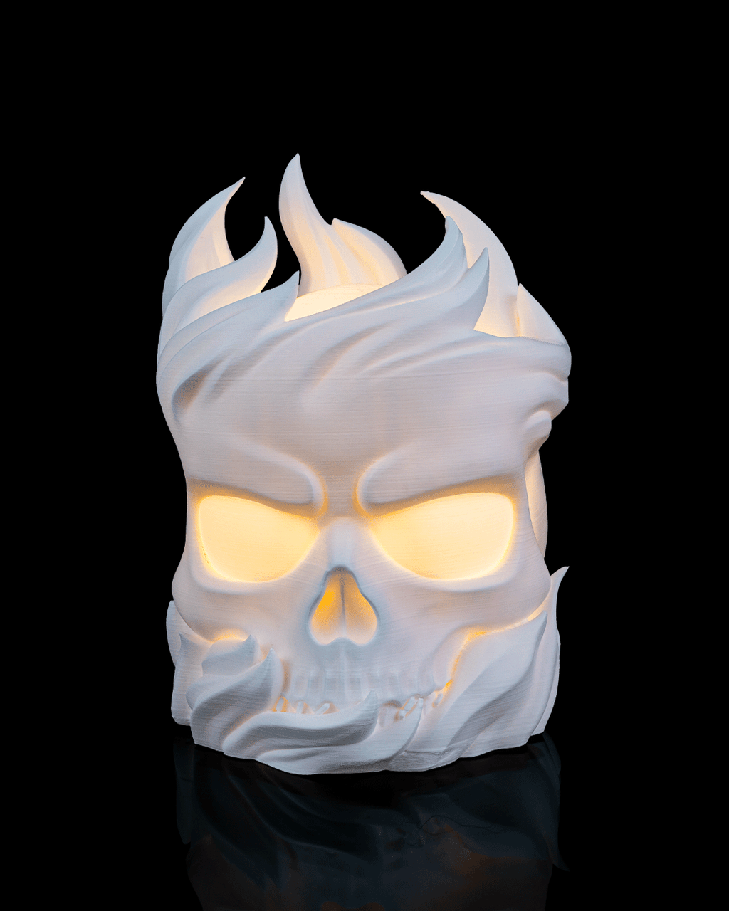 Skull-shaped lamp with flame-like design on a black background
