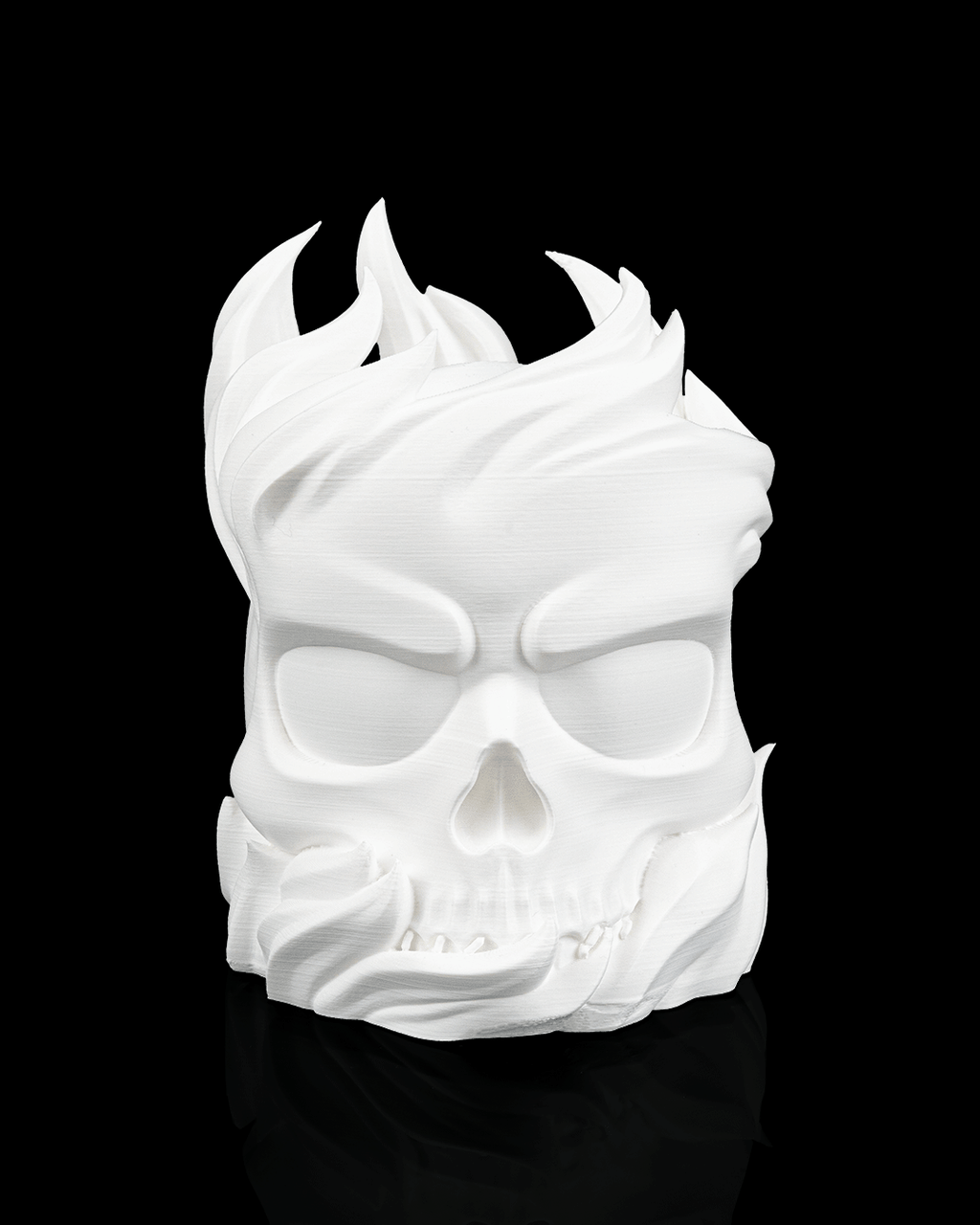 White skull-shaped mask with flames on a black background