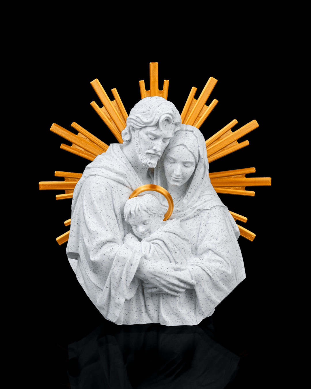 Statue of a holy family with a golden halo against a black background