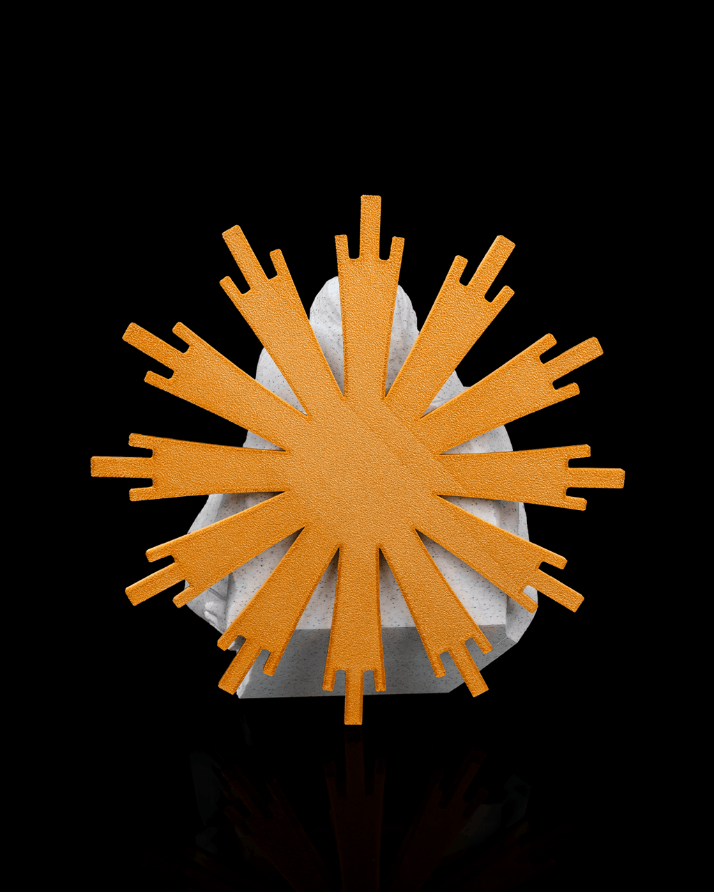 Decorative item with orange sunburst design on a black background