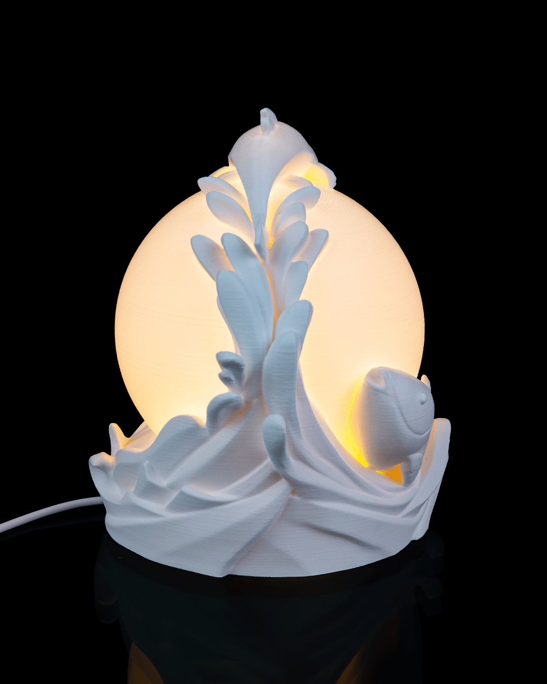 Decorative lamp with a white ceramic design on a black background