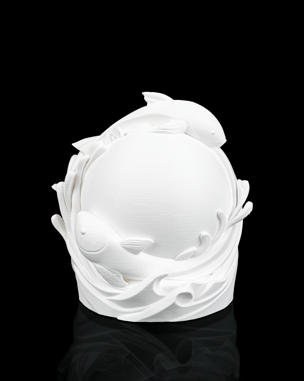 White ceramic sculpture of dolphins on a black background