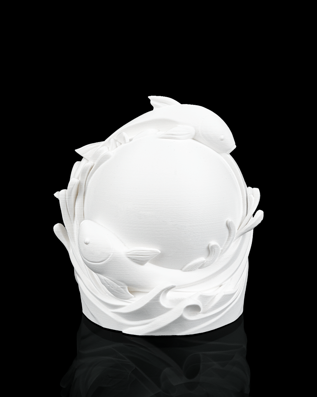 White ceramic sculpture of dolphins on a black background