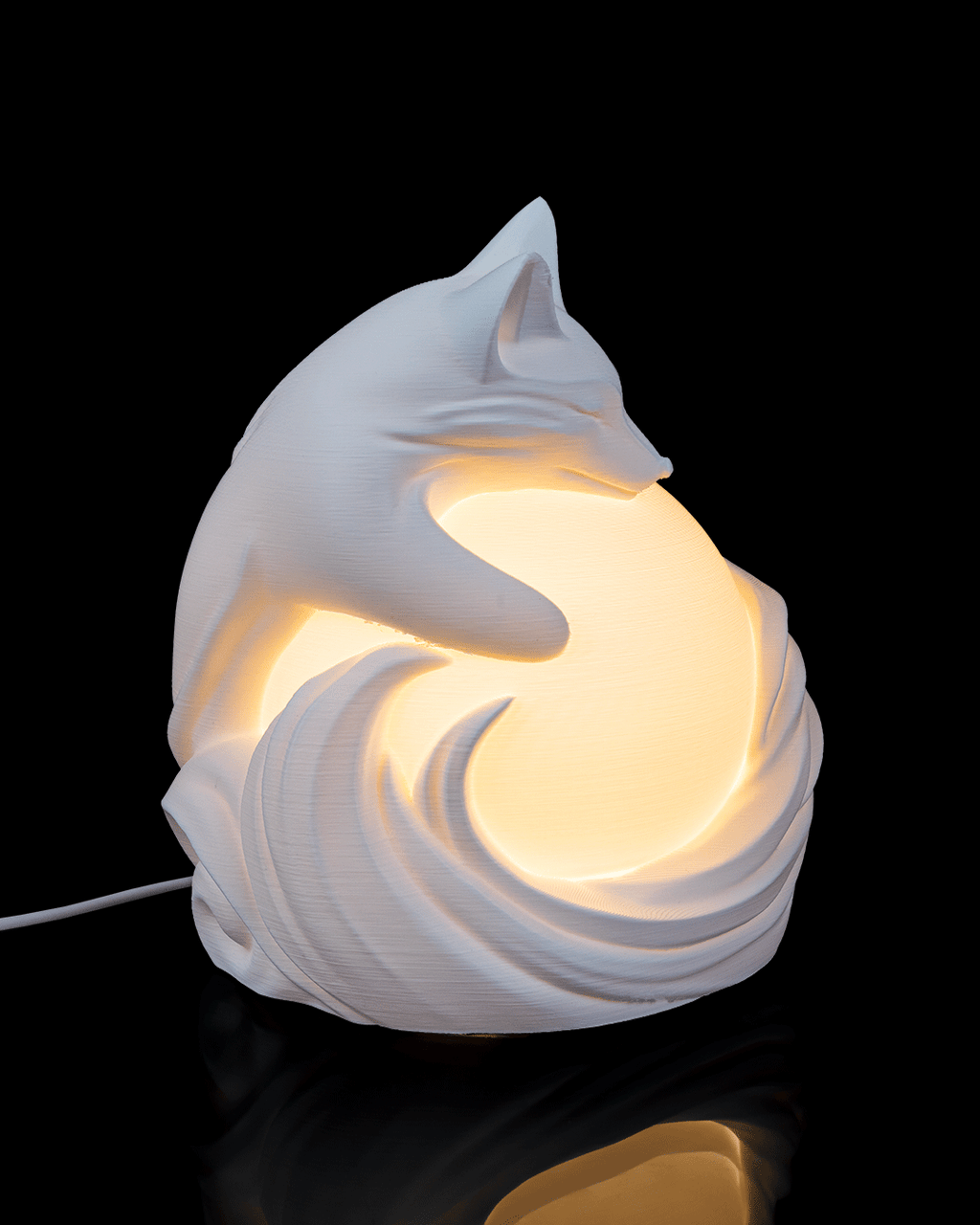 White ceramic fox-shaped lamp on a black background