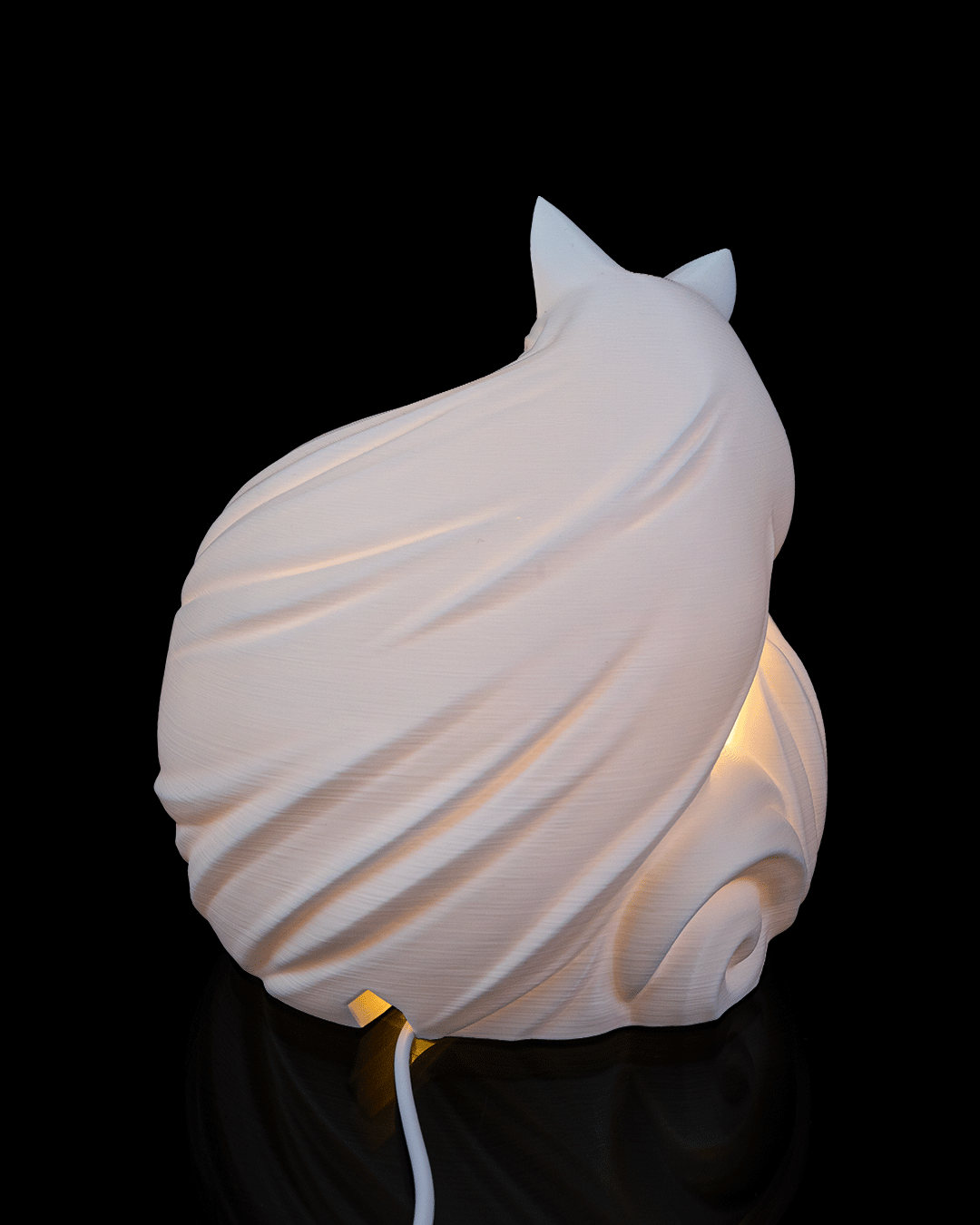 White, wave-like lamp on a black background